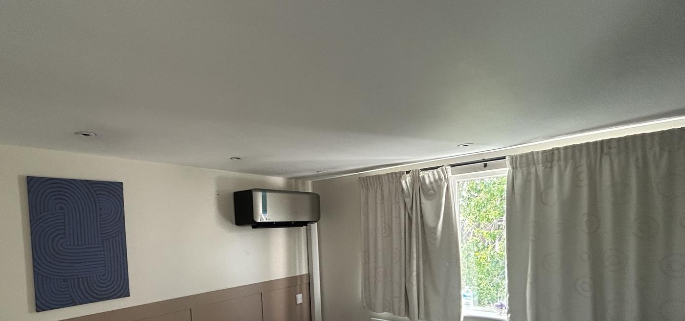 Black finish wall mounted unit in a panelled bedroom