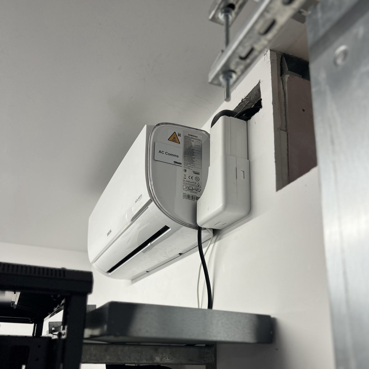 Wall mounted unit with condensate pump cooling a comms room