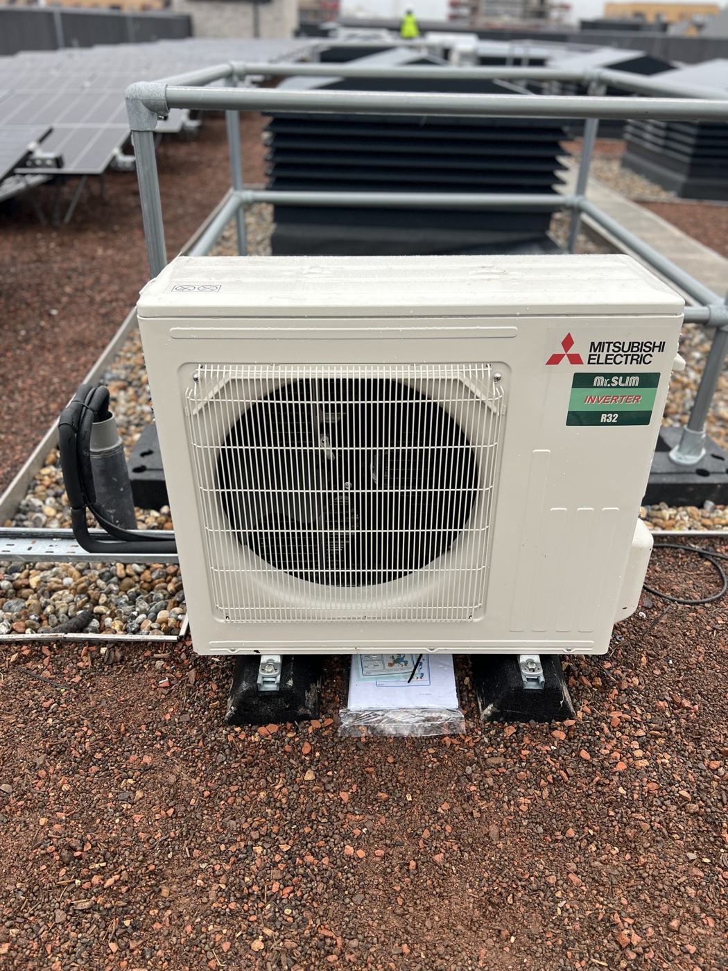 Mitsubishi outdoor unit on a roof mounted support frame
