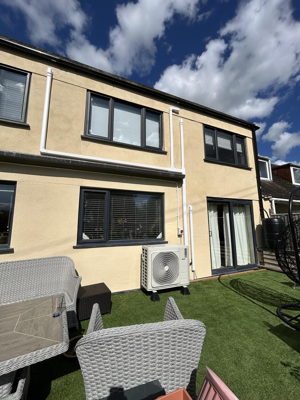 Outdoor unit at the rear of a semi detached house, discreetly positioned