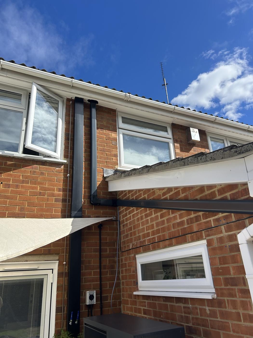 External pipework in black trunking matched to the downpipes