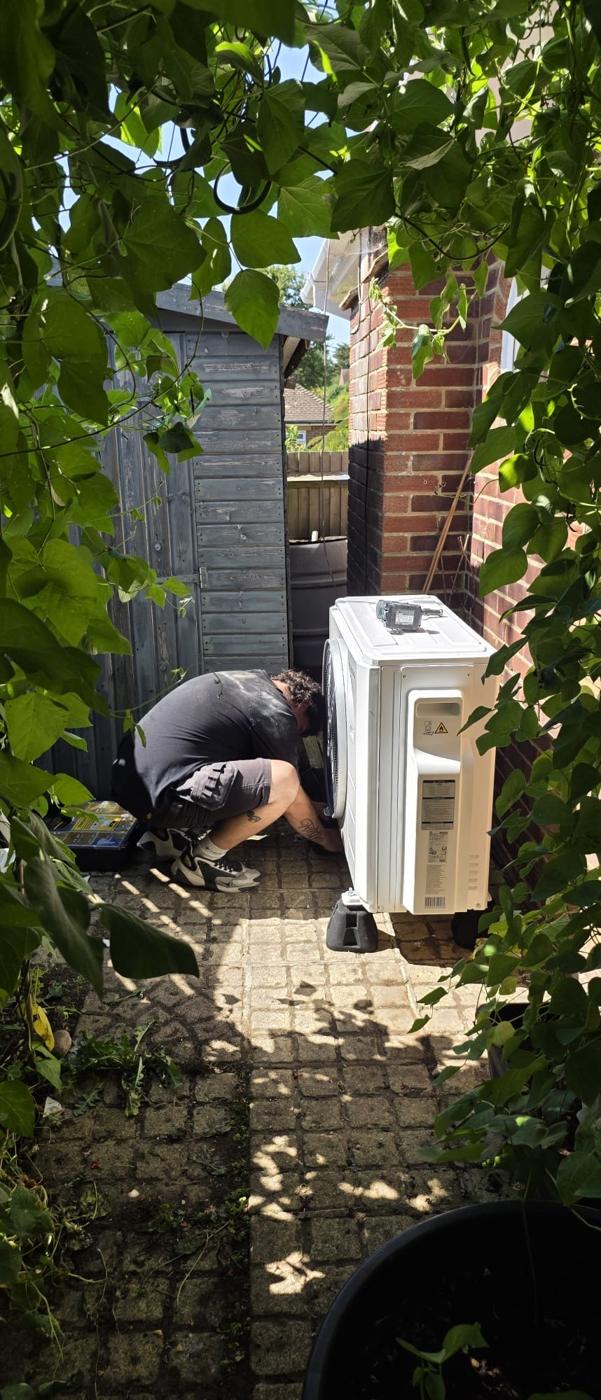 Outdoor unit being set on anti vibration feet down a side passage